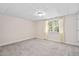 Standard bedroom with carpet, light walls, a ceiling light, and a window with patterned curtains at 9320 Teton Pines Way, Raleigh, NC 27617