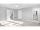 Spacious bedroom with carpet, neutral walls, and adjacent bathroom at 9320 Teton Pines Way, Raleigh, NC 27617