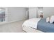 Bright bedroom features plush carpet, a queen bed, and easy access to an exterior door at 9320 Teton Pines Way, Raleigh, NC 27617