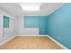 Bright bonus room with two-tone blue and white walls and hardwood flooring at 9320 Teton Pines Way, Raleigh, NC 27617