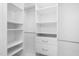 Walk-in closet featuring white shelving and drawers for organized storage at 9320 Teton Pines Way, Raleigh, NC 27617