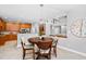 Open-concept dining area showcases dark wood table and decor, connecting seamlessly to the kitchen at 9320 Teton Pines Way, Raleigh, NC 27617
