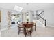 Dining area with a round table, stylish chairs, light fixture, and sliding glass doors to outdoor area at 9320 Teton Pines Way, Raleigh, NC 27617