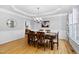 Traditional dining room featuring hardwood floors, decorative molding, and a stylish chandelier at 9320 Teton Pines Way, Raleigh, NC 27617