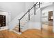 Elegant foyer featuring hardwood floors, staircase, and white wainscoting at 9320 Teton Pines Way, Raleigh, NC 27617