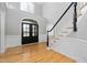 Grand foyer with hardwood floors, a staircase, and a window above the entrance at 9320 Teton Pines Way, Raleigh, NC 27617
