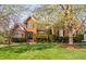 Charming brick home with a manicured lawn and mature trees in full bloom at 9320 Teton Pines Way, Raleigh, NC 27617