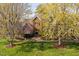 Stately brick home surrounded by flowering trees and a verdant lawn at 9320 Teton Pines Way, Raleigh, NC 27617