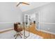 Bright office area with a vaulted ceiling, glass desk, hardwood floors, and natural light at 9320 Teton Pines Way, Raleigh, NC 27617
