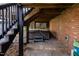 Covered hot tub area with a brick patio and surrounding greenery, for a private retreat at 9320 Teton Pines Way, Raleigh, NC 27617