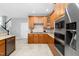 Well-appointed kitchen boasting stainless steel appliances, stone countertops, and seamless access to the staircase at 9320 Teton Pines Way, Raleigh, NC 27617