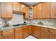 Classic kitchen with stone countertops, gas range, and ample cabinet storage at 9320 Teton Pines Way, Raleigh, NC 27617