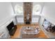 A bird's eye view of a living room featuring a stone fireplace, hardwood floors, and lots of light at 9320 Teton Pines Way, Raleigh, NC 27617