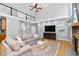 Comfortable living room with a stone fireplace, hardwood floors, and ample seating at 9320 Teton Pines Way, Raleigh, NC 27617