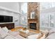 Open concept living area with a stone fireplace, hardwood floors, and vaulted ceiling at 9320 Teton Pines Way, Raleigh, NC 27617
