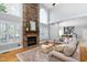 Spacious living room with a stone fireplace, large windows, and hardwood floors at 9320 Teton Pines Way, Raleigh, NC 27617