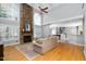 Inviting living room with a stone fireplace, hardwood floors, and great natural light at 9320 Teton Pines Way, Raleigh, NC 27617
