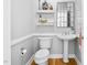 Stylish powder room featuring a pedestal sink, shelving, and decorative mirror at 9320 Teton Pines Way, Raleigh, NC 27617