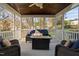 Relaxing screened porch with comfortable seating and a cozy fire pit, perfect for outdoor enjoyment at 9320 Teton Pines Way, Raleigh, NC 27617
