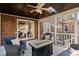 Brick screened in porch with comfortable furniture, tile-topped fire pit and brick exterior, for relaxing evenings at 9320 Teton Pines Way, Raleigh, NC 27617