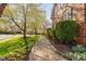 Brick walkway along a lush landscaped yard with mature trees at 9320 Teton Pines Way, Raleigh, NC 27617