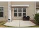 Concrete backyard patio featuring a retractable awning at 1008 Garden Square Ln, Morrisville, NC 27560