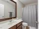 Well-lit bathroom with a classic vanity and mirror, next to a shower with patterned curtain at 1008 Garden Square Ln, Morrisville, NC 27560