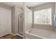Bathroom with a separate shower and tub, complemented by a large window for natural light at 1008 Garden Square Ln, Morrisville, NC 27560