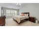 Well-lit bedroom with neutral tones, complemented by a spacious bed and comfortable furnishings at 1008 Garden Square Ln, Morrisville, NC 27560