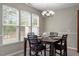 Bright dining room features natural light from three windows and a modern chandelier above table at 1008 Garden Square Ln, Morrisville, NC 27560