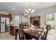 Dining room boasts table set for four with chandelier, wood accent wall, and kitchen view at 1008 Garden Square Ln, Morrisville, NC 27560