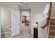 Open foyer featuring hardwood floors, stairs, and an arched doorway leading to the living room at 1008 Garden Square Ln, Morrisville, NC 27560