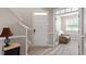 Welcoming foyer with elegant staircase, stylish flooring, and a glimpse into a cozy sitting room at 1008 Garden Square Ln, Morrisville, NC 27560