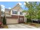 Two-story home with brick and siding, a two-car garage, and well-maintained landscaping at 1008 Garden Square Ln, Morrisville, NC 27560