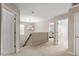 Upstairs hallway features neutral carpet, updated lighting, with bedrooms and a bathroom nearby at 1008 Garden Square Ln, Morrisville, NC 27560