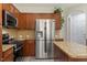 Bright kitchen with stainless steel refrigerator, granite countertops, and ample wood cabinetry at 1008 Garden Square Ln, Morrisville, NC 27560