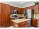Kitchen with custom wood cabinets, granite countertops, stainless steel appliances, and a kitchen island at 1008 Garden Square Ln, Morrisville, NC 27560