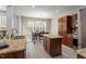 Spacious kitchen showcases central island, stainless steel appliances, and dining area with natural light at 1008 Garden Square Ln, Morrisville, NC 27560