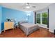 Cozy bedroom with natural light, hardwood floors, ceiling fan and a light blue accent wall at 101 Hunting Chase # 2B, Cary, NC 27513