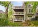 Exterior of a three story townhome with multiple wooden decks in a wooded area at 101 Hunting Chase # 2B, Cary, NC 27513