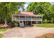 Charming building with a covered porch and staircase set amid lush trees at 101 Hunting Chase # 2B, Cary, NC 27513