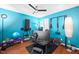 Home gym with blue walls, fitness equipment, hardwood floors, and a ceiling fan at 101 Hunting Chase # 2B, Cary, NC 27513