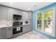 Updated kitchen featuring stainless steel appliances, quartz countertops, and modern pendant lighting at 101 Hunting Chase # 2B, Cary, NC 27513
