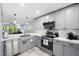 Updated kitchen featuring stainless steel appliances, quartz countertops, and modern pendant lighting at 101 Hunting Chase # 2B, Cary, NC 27513