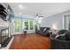 Spacious living room boasts hardwood floors, a cozy fireplace, and lots of natural light at 101 Hunting Chase # 2B, Cary, NC 27513