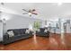 A spacious living room with hardwood floors and ceiling fan opens to the kitchen area with a breakfast bar at 101 Hunting Chase # 2B, Cary, NC 27513