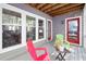 Inviting covered porch with gray flooring, red doors, and plenty of natural light at 101 Hunting Chase # 2B, Cary, NC 27513