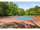 Outdoor tennis courts featuring blue playing surfaces and green surroundings at 101 Hunting Chase # 2B, Cary, NC 27513