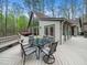 Inviting back deck with a table and chairs perfect for enjoying the surrounding nature at 109 Barcliff Ter, Cary, NC 27518