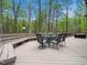 Large deck with dining furniture and outdoor seating, perfect for enjoying the tranquil surrounding nature views at 109 Barcliff Ter, Cary, NC 27518